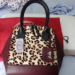 Sharif - Wine w/black leather trim/cowhair center